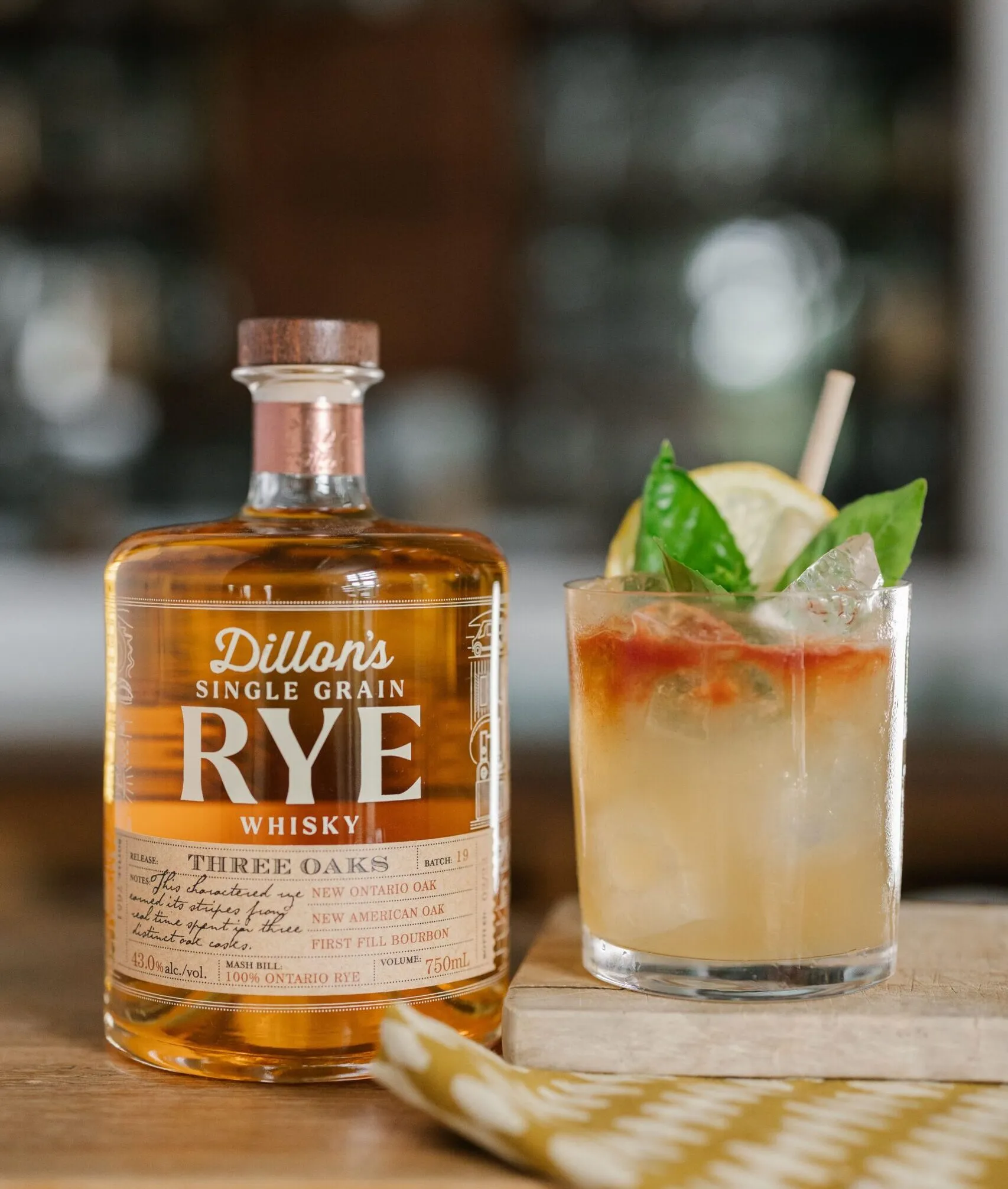 Rye Whisky Smash A bottle of rye whisky alongside a cocktail